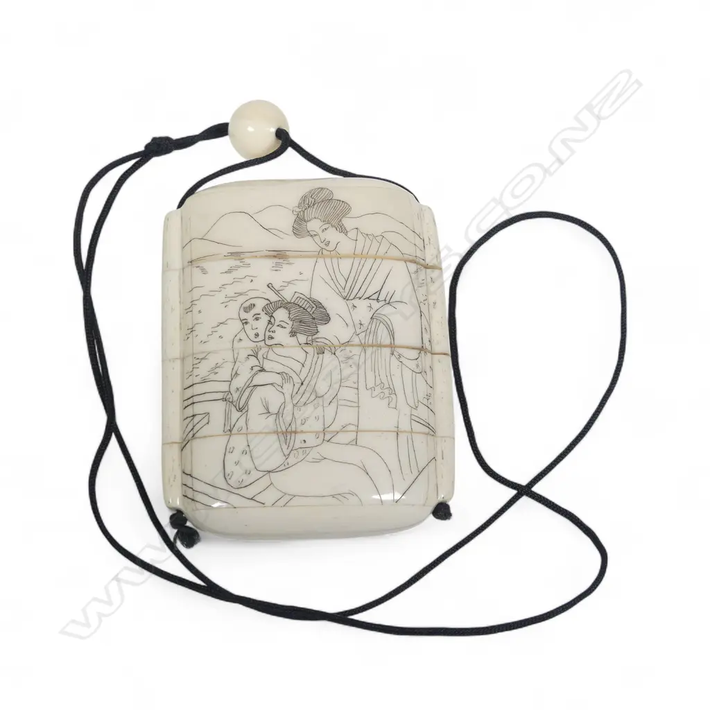 A sectional bone inro, of four compartments, engraved with a boating party to one side and a hawk to the other. H.75mm Image 1++