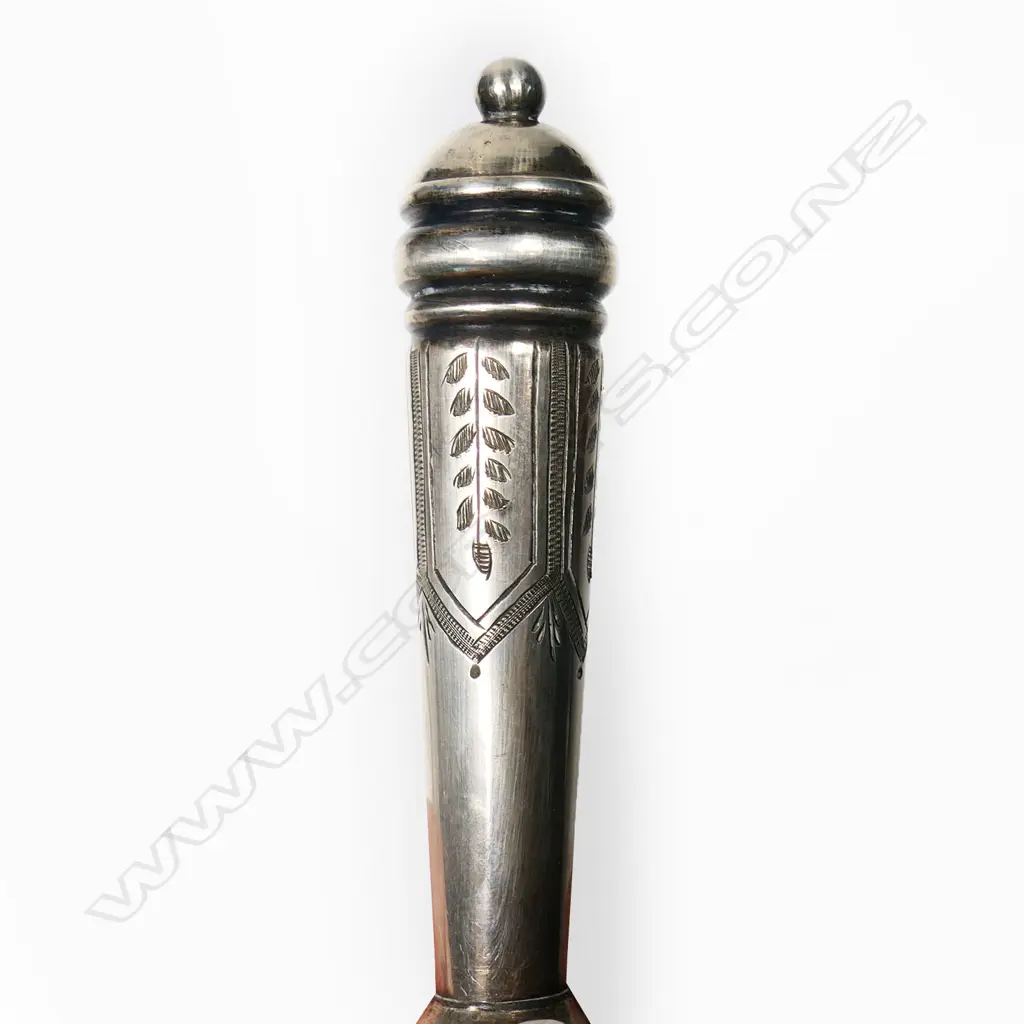 A late Victorian silver plated tussie-mussie, the cone pierced and engraved with stiff leaves, on a tapering handle with pennant frieze engraving. With finger-ring and pin on chains. H.135mm Image 1++