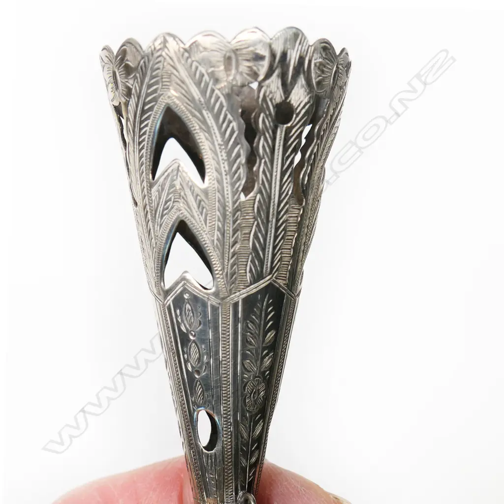 A late Victorian silver plated tussie-mussie, the cone pierced and engraved with stiff leaves, on a tapering handle with pennant frieze engraving. With finger-ring and pin on chains. H.135mm Image 1++