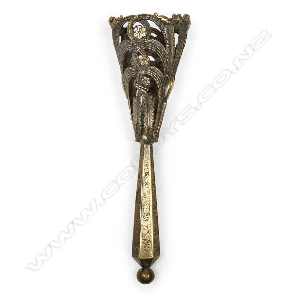 A gilt brass bouquet holder, possibly French, the cone cast and pierced with acanthus and lilies, on a hexagonal tapering handle. H.155mm Image 1++
