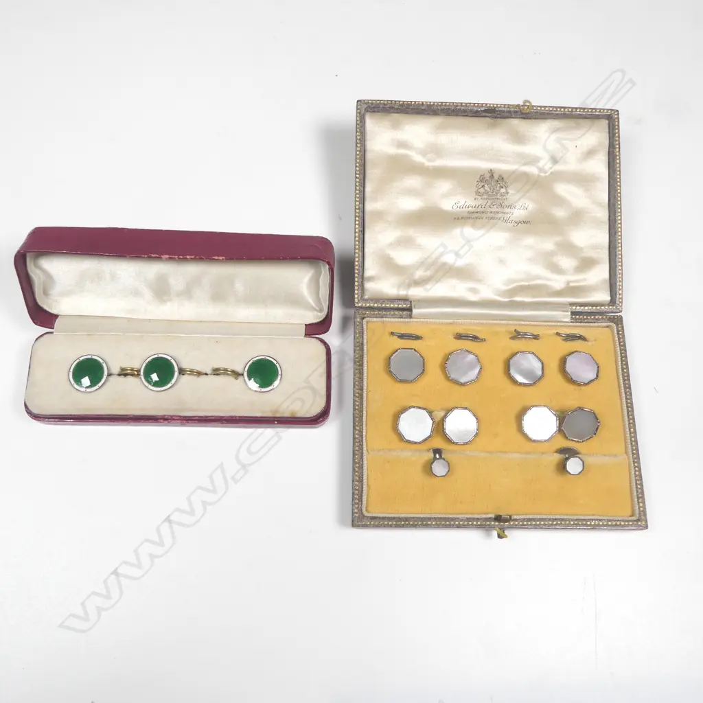 A set of gentlemen's silver cufflinks, waistcoat buttons and collar studs, with octagonal mother of pearl faces; and a set of three silver and emerald enamel waistcoat buttons. Both in original boxes. Image 1++