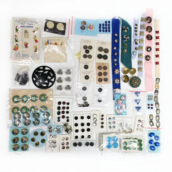 Two trays of various fancy enamel and other sew on and detachable buttons