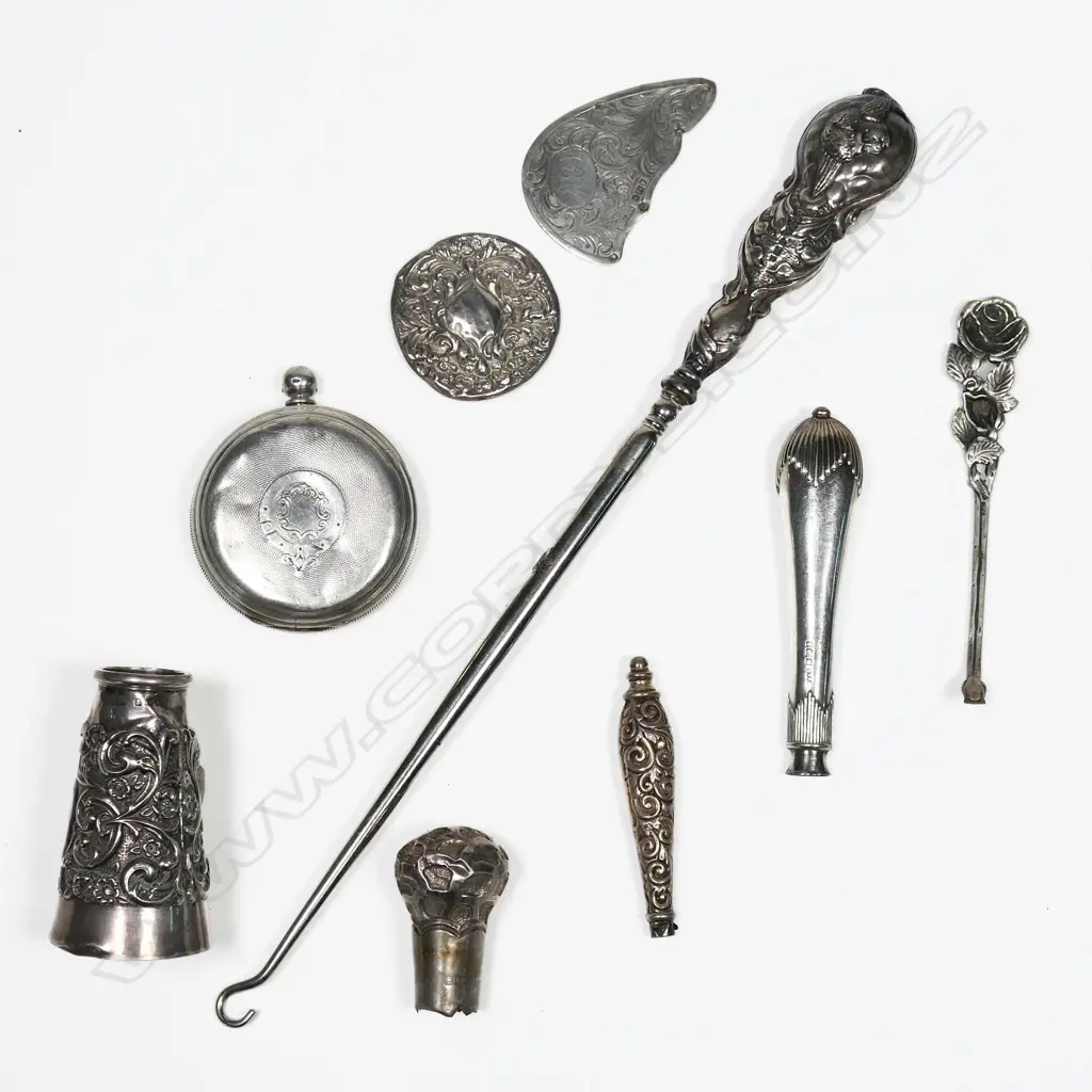 A large sterling silver Reynolds Angels button hook, B'ham 1906 (dents) along with a silver walking cane top and other scrap silver. Image 1++