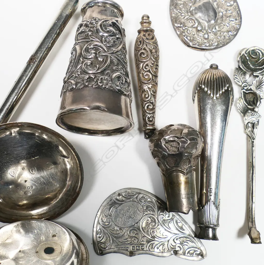 A large sterling silver Reynolds Angels button hook, B'ham 1906 (dents) along with a silver walking cane top and other scrap silver. Image 1++