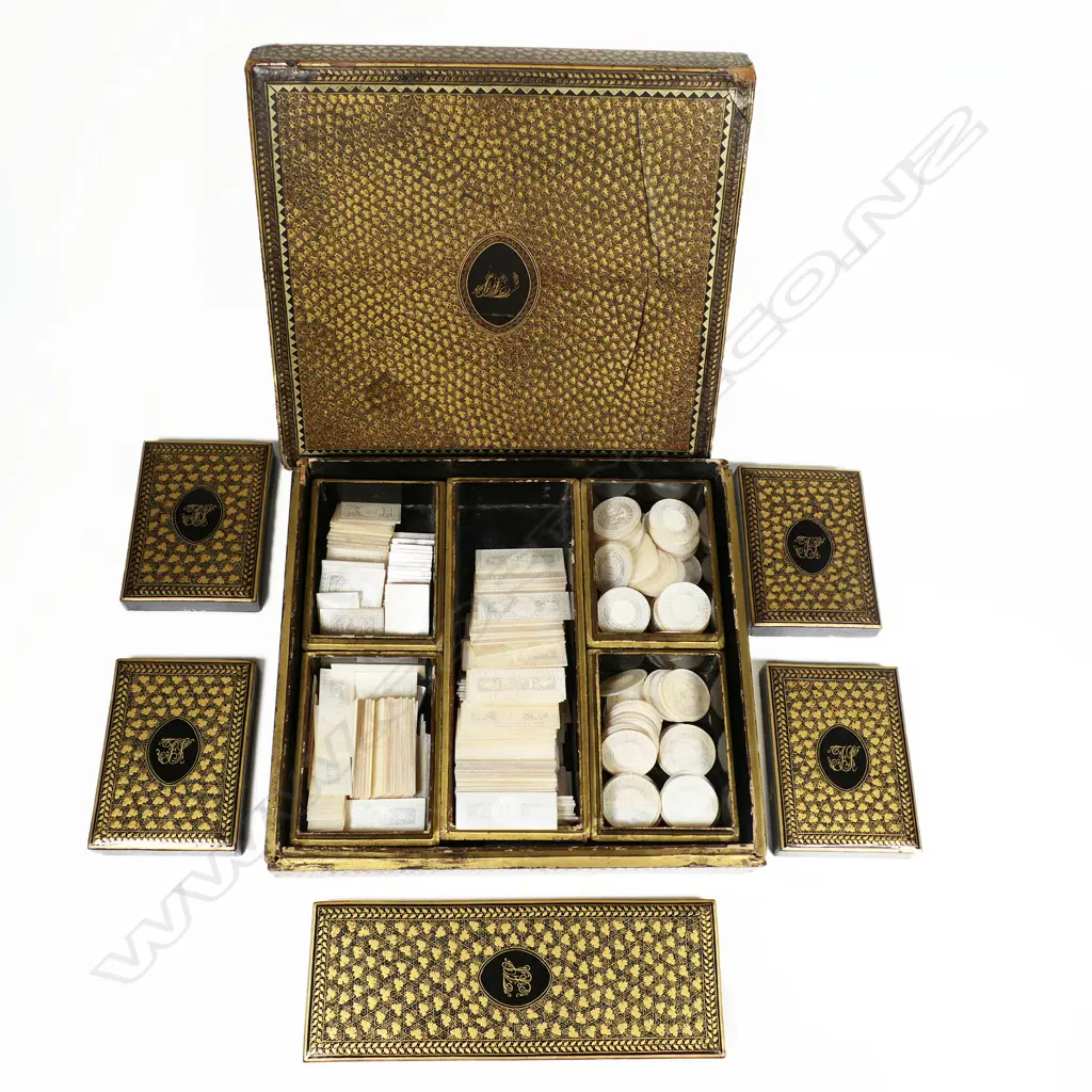 An 18thC multiple boxed set of approximately 310 bespoke engraved Chinese mother-of-pearl gaming counters, housed in a square lidded box holding five further boxes, each gold lacquered and monogrammed 'FS' to the lids, circa 1790 Image 1++