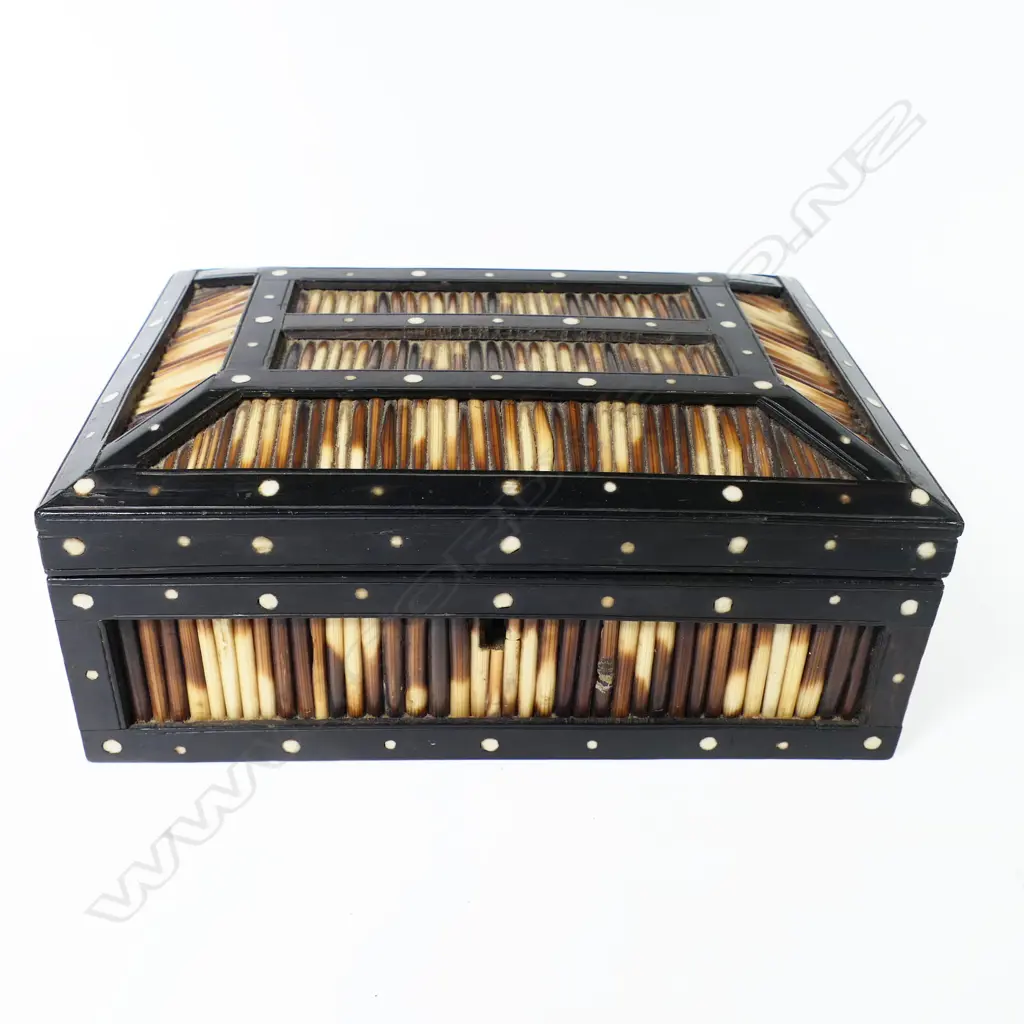 A late 19thC Ceylonese porcupine quill box, with hinged casket lid, the quill panels framed by ebony inlaid with bone rondels. 210 x 160 x 85mm Image 1++