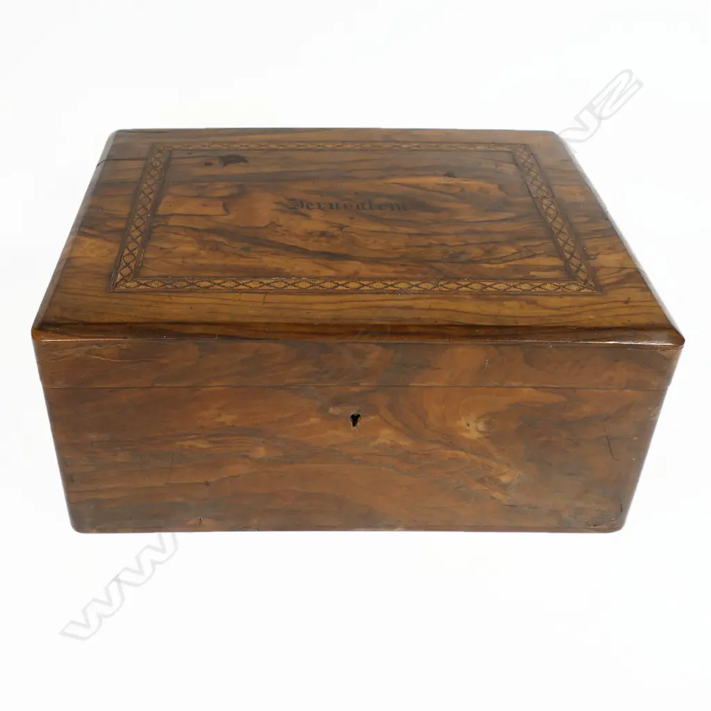 An olive wood work box, souvenir of a pilgrimage to the Middle East, oblong, undecorated except for a band of fine Tunbridge inlay framing the inked name 'Jerusalem'. Interior fitted with a lift out upper tier of small lidded compartments, silk winders and pincushion. 255 x 155 x 110mm Image 1++
