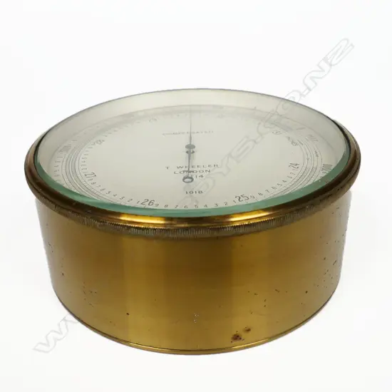 A WW1 1918 dated British Naval barometer/altimeter by T. Wheeler, London the dial marked 'Compensated, T. Wheeler , London, 4114, 1918', in a brass case marked verso with broad arrow mark,