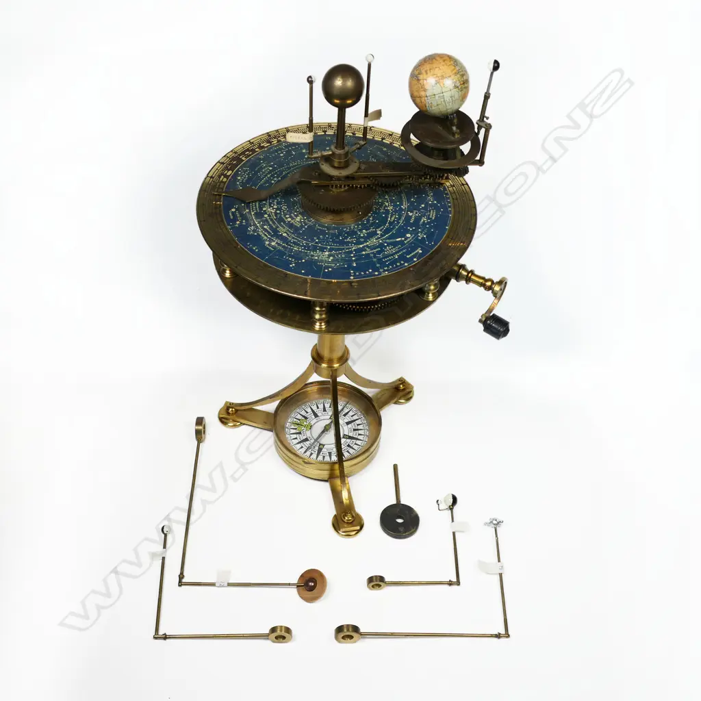 A 20thC brass drum top planetarium, the inner planets and sun raised above a plate with celestial map within an engraved calendar dial, Image 1++