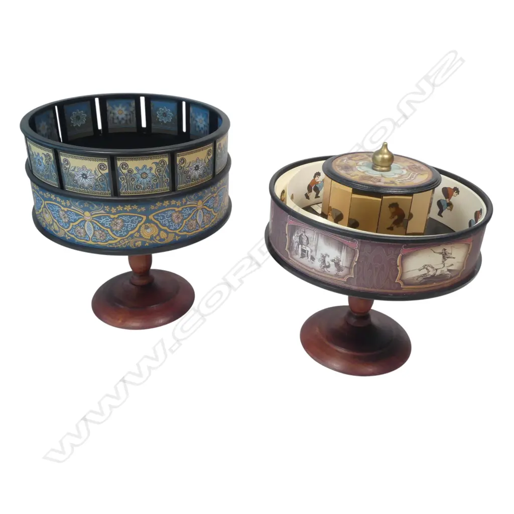 Two contemporary animation viewers by Hemisferium, a zoetrope and a praxinoscope, with approximately 30 animation strips, each rotating ring on turned wooden column base. H.220mm Image 1++