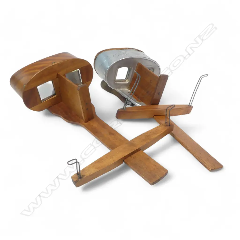 Two handheld stereoscopic viewers, one with zinc mounts marked Underwood & Underwood, New York. Image 1++