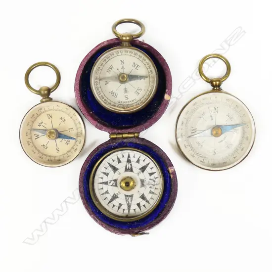 Four small pocket compasses; three open face with fob suspension and a floating dial in purple leatherette hinged case,