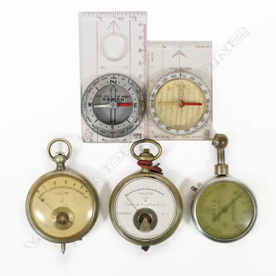 Two pocket watch-type voltmeters; US Gauge Co., NY tire pressure gauge; Silva Type 5 induction damped compass c.1960; and a Silva Type 342 compass. (5)