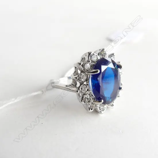 FAUX SAPPHIRE AND WHITE STONE RING IN SILVER PLATE