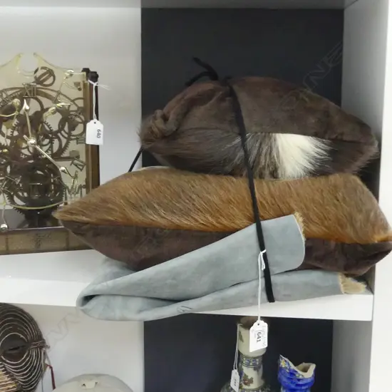 TWO HIDE CUSHIONS AND A HIDE RUG