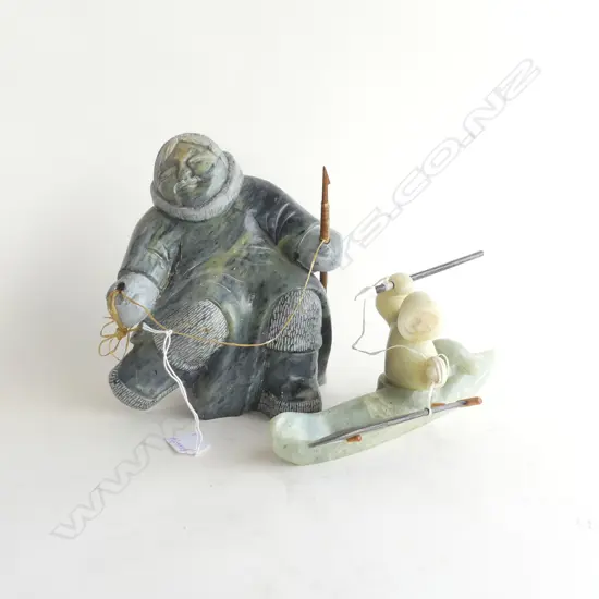 2 ALASKAN INUIT CARVED STONE SCULPTURES; WOMAN H.205mm & CANOE HUNTER L.250mm