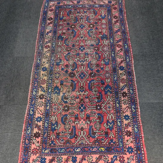 HAND KNOTTED WOOL PILE RUG 1900x950mm showing some wear