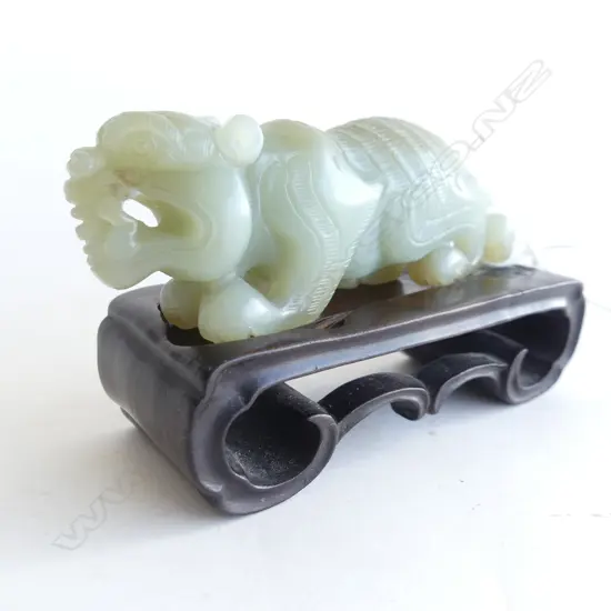 CHINESE GREEN HARDSTONE CARVED TIGER ON WOODEN STAND L.90mm