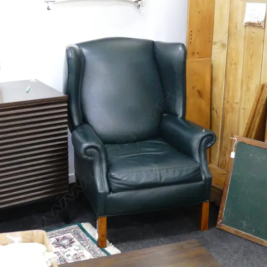DARK GREEN MODERN WINGBACK CHAIR. NEEDS SOME ATTENTION.
