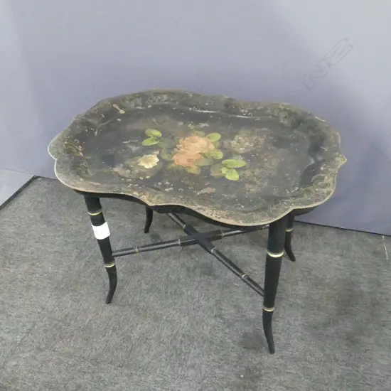 19THC SERPENTINE SHAPED  OCCASIONAL TABLE. THE TIN TRAY TABLE TOP HANDPAINTED, GILT DETAIL TO EBONISED BASE. L. 680mm