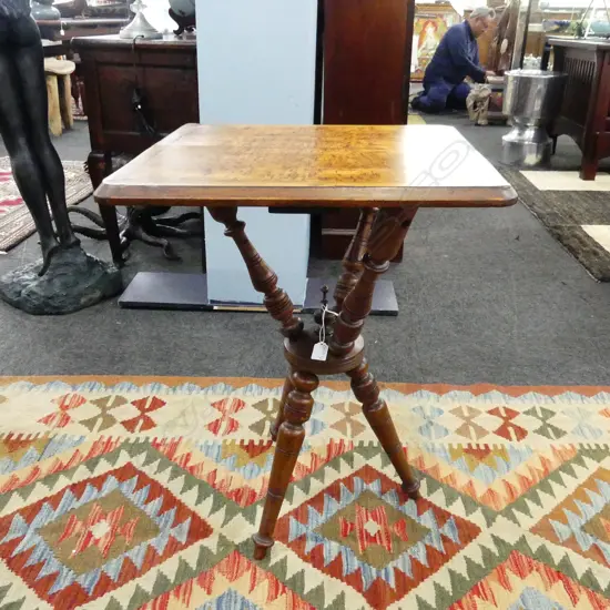 KAURI COLONIAL OCCASIONAL TABLE. SQUARE TOP IN BOOK VENEERED FLAME KAURI WITH REWAREWA BORDER. ON A GYPSY BASE. H. 700mm