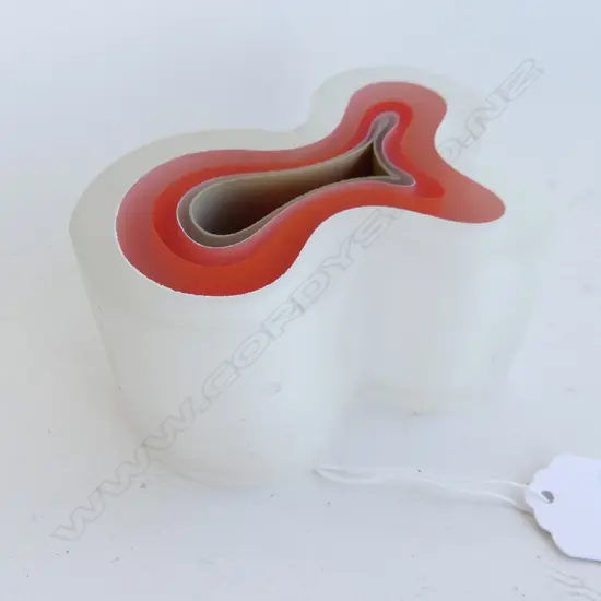 GLASS SCULPTURE BY DOMINIC BURRELL. LAYERED GLASS GRADUATING FROM RED CENTRE.SERPENTINE SHAPED DIA 80mm