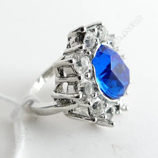 SILVER COLOUR  RING WITH LG SYNTHETIC SAPPHIRE & WHITE STONES