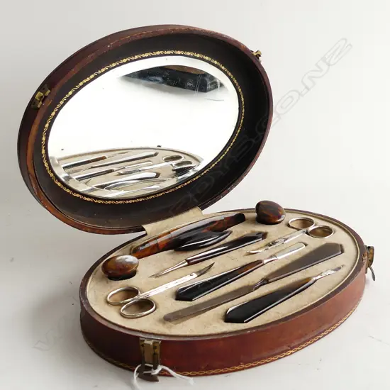VINTAGE TORTOISESHELL MANICURE SET IN OVAL LEATHER CASE c.1920 W.250mm