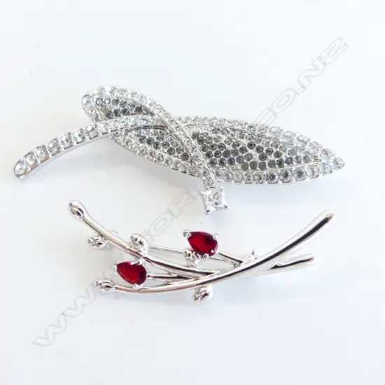 2 ANGELIQUE SILVERTONE BROOCHES; ONE WITH DIAMANTES & ONE WITH FAUX RUBIES