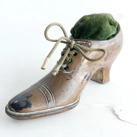 ANTIQUE PIN CUSHION, HEELED SHOE FORM, METAL w. COPPER PLATING L.145mm