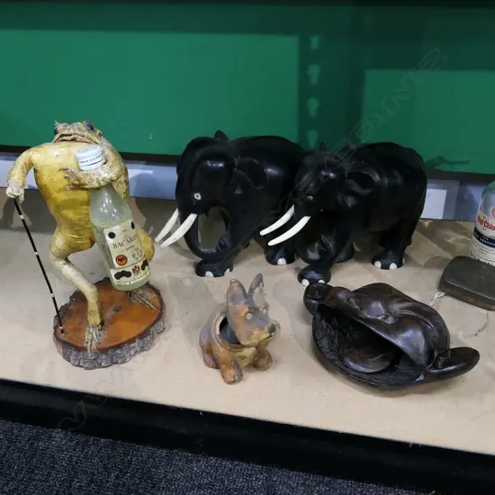 BOX LOT 2 EBONY ELEPHANTS, TAXIDERMIED FROG, CARVED WOODEN FACE BELL ETC