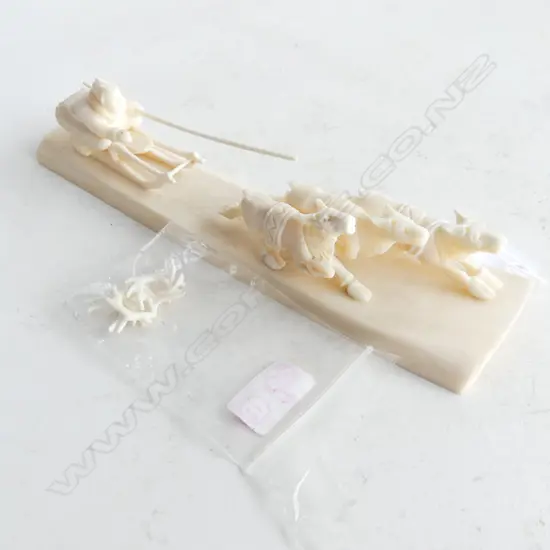 SIGNED CARVED BONE w. INUIT MAN ON SLED PULLED BY 3 REINDEER L.195mm