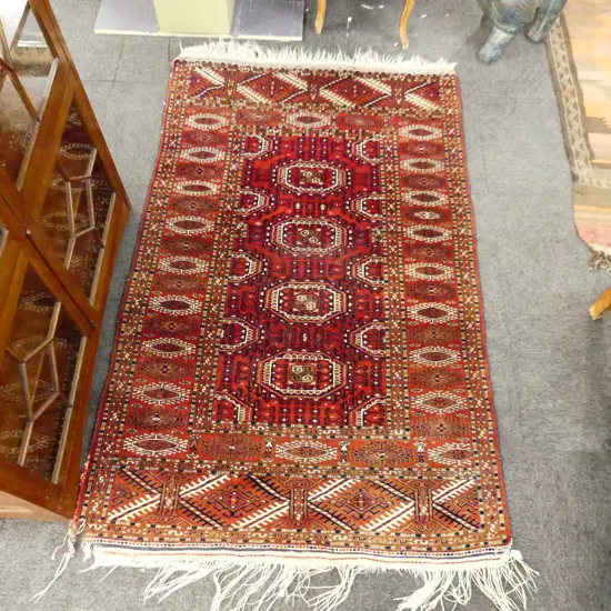 HAND KNOTTED TURKOMAN RUG WITH  DAMAGE TO ONE CORNER 1960 X 1200 MM