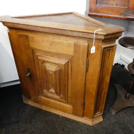 AN OAK CORNER CUPBOARD WITH PANELED FRONT H 740 MM