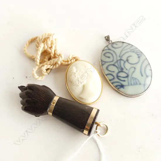 3 PENDANTS; NINA RICCI CAMEO, B/W CERAMIC, EBONISED CLENCHED FIST L.75mm