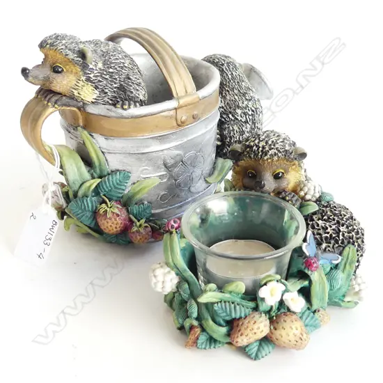 2 BRAMBLE & CLOVER HEDGEHOG ORNAMENTS; 1 WITH WATERING CAN (H. 130MM) & ONE WITH TEA LIGHT CANDLE (H. 90MM)
