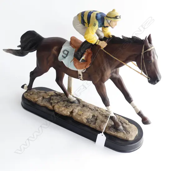 A CAST RESIN MOLDED RACEHORSE AND JOCKEY ON WOODEN BASE L 420 MM 