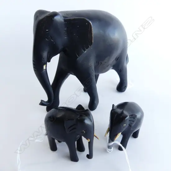 THREE EBONY ELEPHANTS. LARGEST H.150mm SMALLEST H. 55mm. SOME TUSK DAMAGE.
