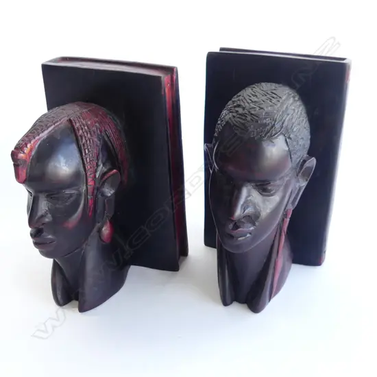PAIR OF EBONY CARVED BOOKENDS WITH FAUX BOOK PART. AS MALE AFRICAN WARRIORS WITH RED ACCENTS. H.200mm RED ACCENTS 