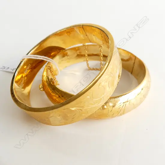 TWO VINTAGE GOLD PLATED HINGED BRACELETS WITH SAFETY CHAINS  