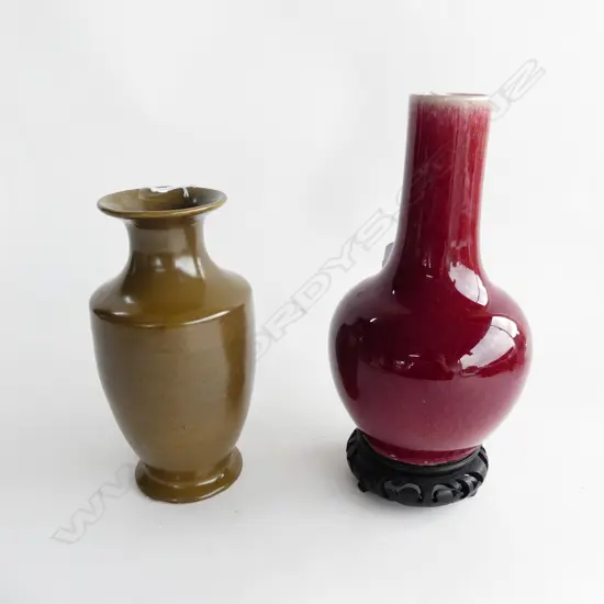2 ORIENTAL POTTERY VASES; TEA GLAZE WITH WOODEN STAND (H. 205MM) & RED GLAZE (H. 200MM)