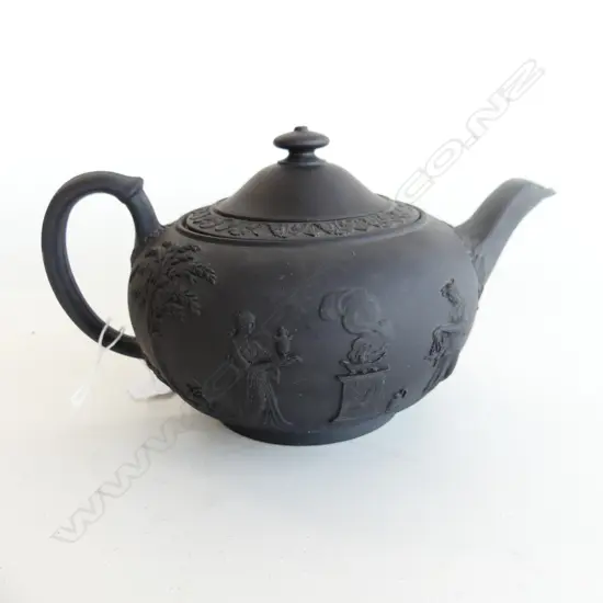 19THC WEDGWOOD BLACK BASALT TEAPOT. WITH GREEK SCENES IN RELIEF. SLIGHT FRIT TO SPOUT. W. 200mm H. 120mm