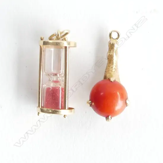 2 X 9CT GOLD CHARMS. EGG TIMER, AND GOLD CLAW WITH CORAL BALL