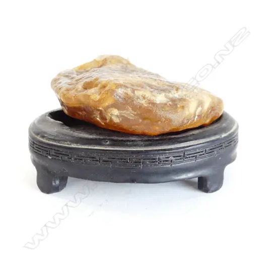 POLISHED STONE ON SHAPED EBONISED STAND W.100mm