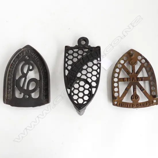 THREE VICTORIAN CAST IRON TRIVETS FOR IRONS – THE BEETALL, ENTERPRISE USA ETC.