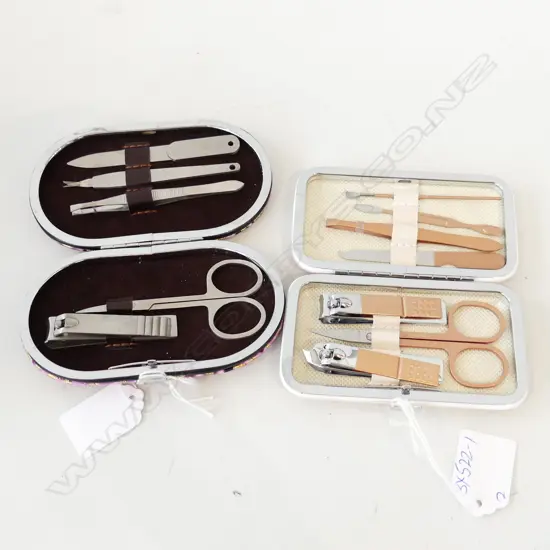 TWO BOXED MANICURE SETS. ONE PINK/GOLD 