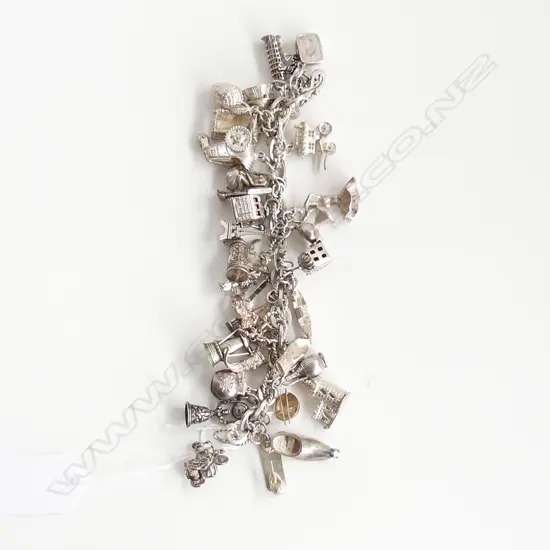 SILVER CHARM BRACELET WITH 32 CHARMS 132gn