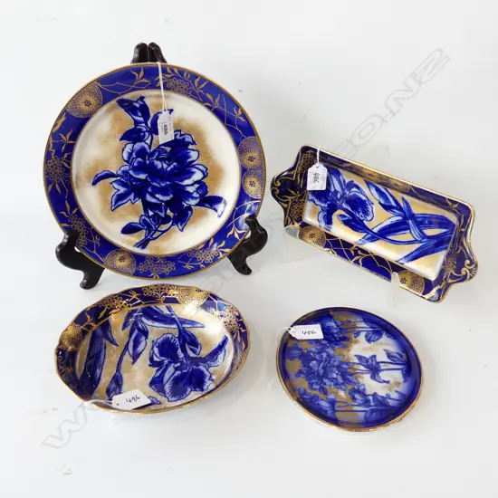 FOUR DOULTON BURSLEM ITEMS TWO IN THE IRIS PATTERN . CAKE PLATE BOWL PLATE AND TEAPOT STAND