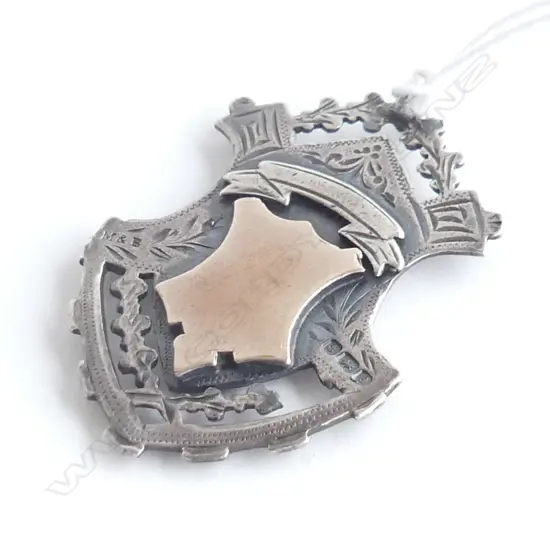 C1900 SILVER & GOLD FOB MEDALLION shield form fret cut