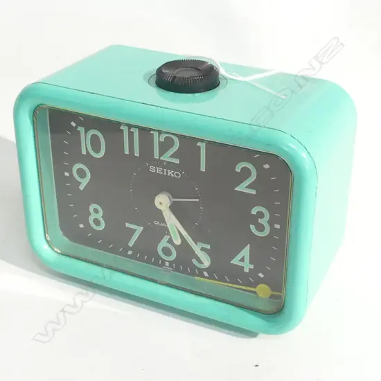 1970'S SEIKO GREEN ALARM CLOCK - REPORTED WORKING BUT NO BATTERIES; ALARM HAND LOOSE L 132MM